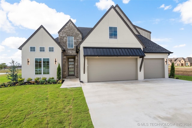 modern farmhouse with a front yard and a garage