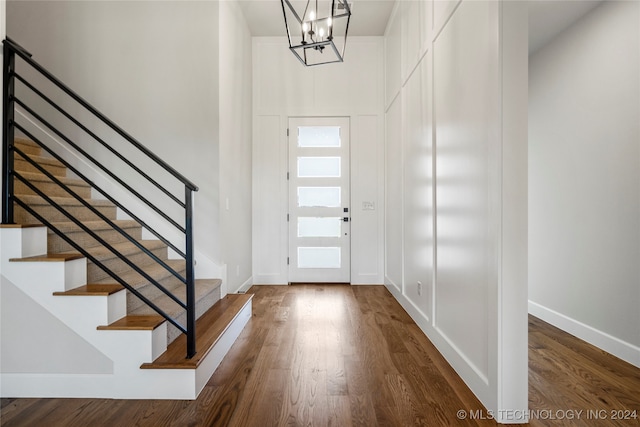 entrance foyer featuring hardwood / wood-style floors and a notable chandelier