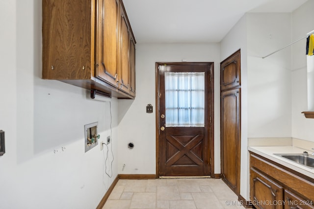 washroom featuring sink, washer hookup, and cabinets