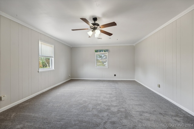 carpeted spare room featuring crown molding, a healthy amount of sunlight, and ceiling fan