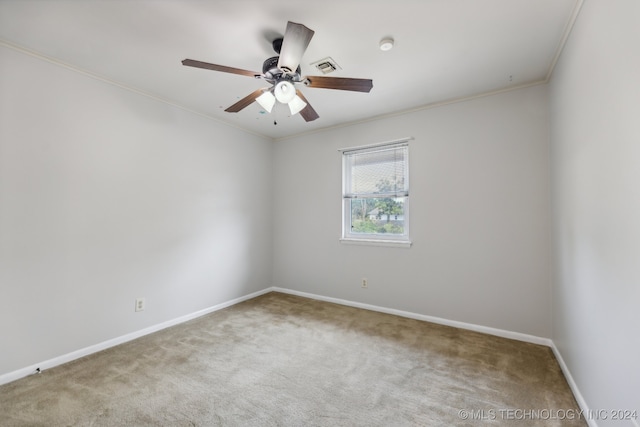 carpeted empty room featuring crown molding and ceiling fan