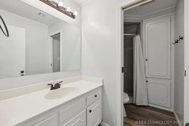 bathroom featuring a shower with shower curtain, toilet, vanity, crown molding, and hardwood / wood-style flooring