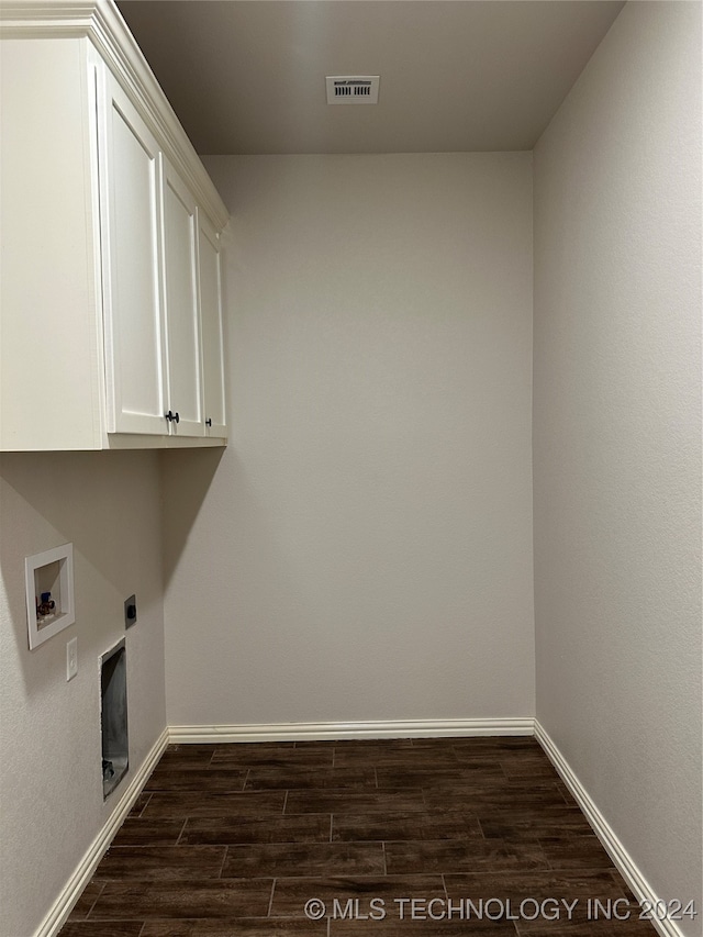 laundry area with cabinets, hookup for a washing machine, dark wood-type flooring, and hookup for an electric dryer