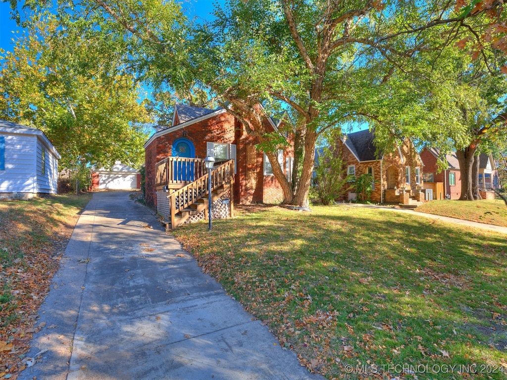 view of front of home with a garage and a front lawn