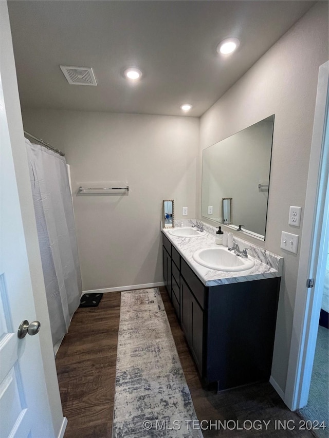 bathroom with vanity and hardwood / wood-style flooring