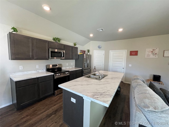 kitchen featuring dark wood-type flooring, stainless steel appliances, a center island with sink, and sink