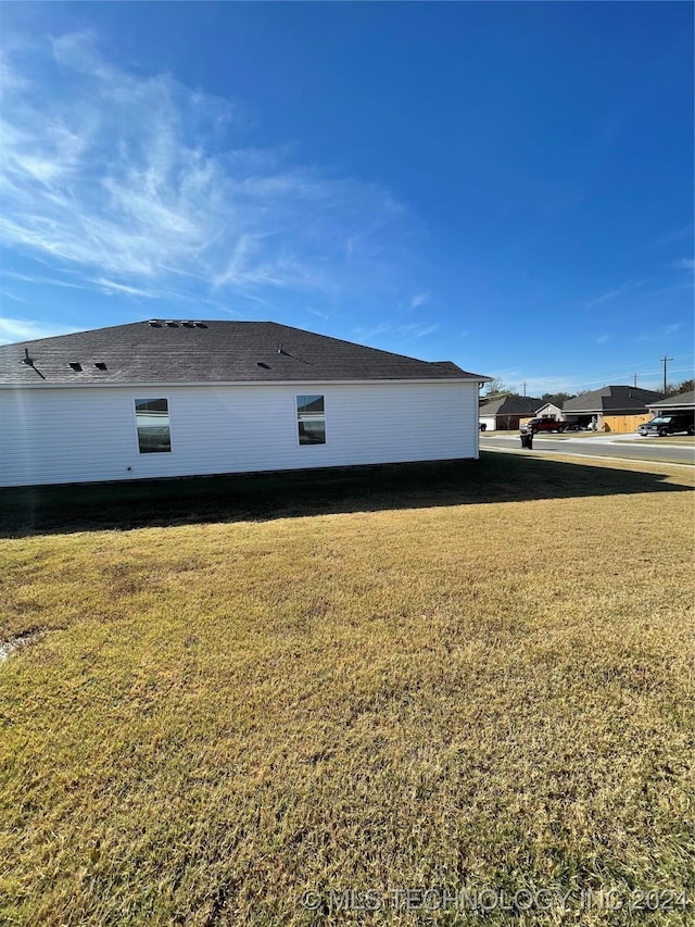 view of side of home with a lawn