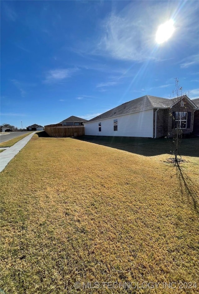 view of side of property with a lawn