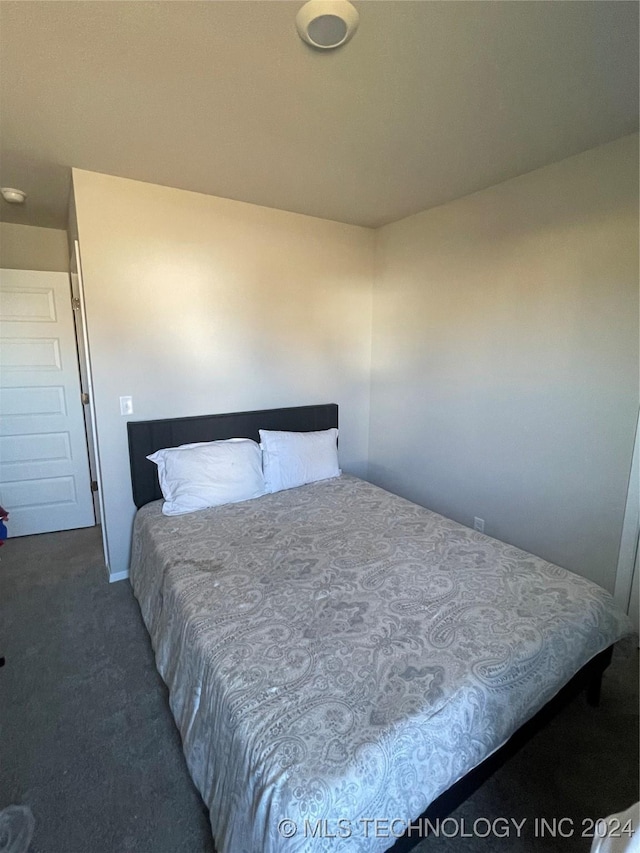 bedroom featuring dark carpet