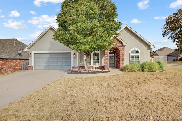 view of front of property with a front lawn and a garage