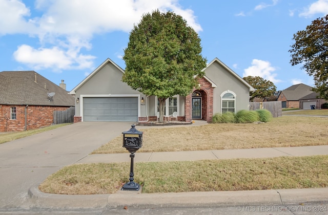 view of front facade with a front yard and a garage