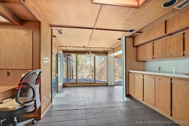 kitchen with tile patterned floors, a notable chandelier, and wood ceiling