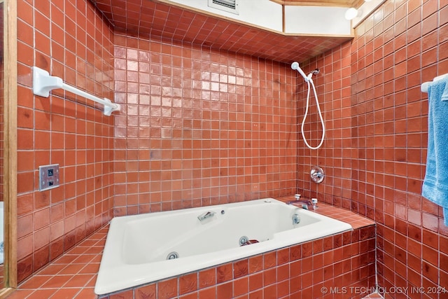 bathroom with tile patterned floors and tile walls