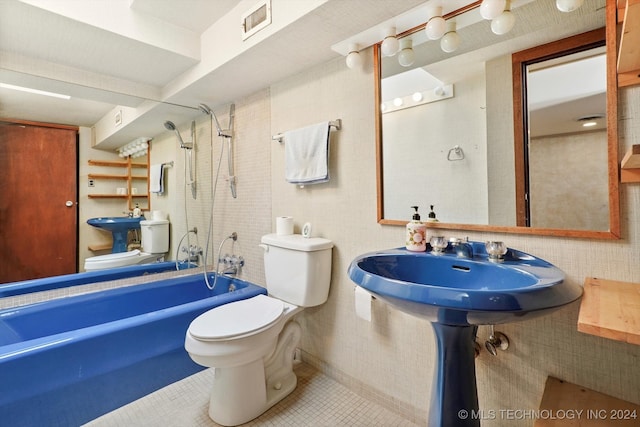 bathroom with toilet, tiled shower / bath combo, and tile patterned floors