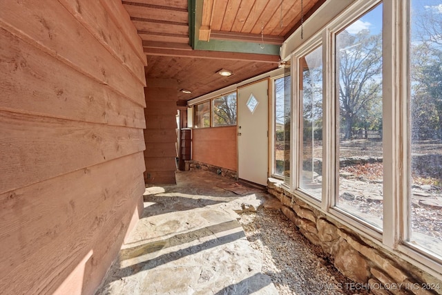 unfurnished sunroom featuring a wealth of natural light