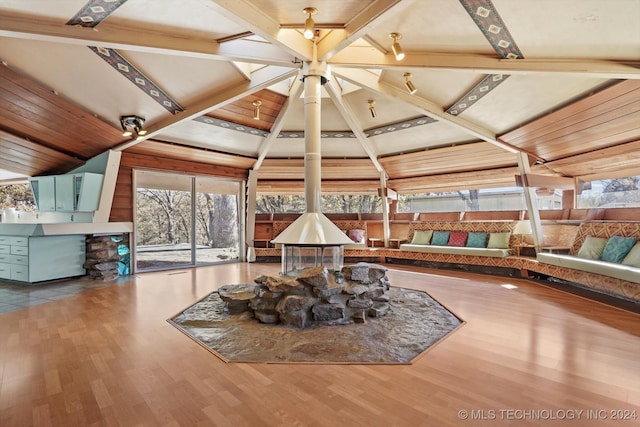 interior space featuring wood ceiling, hardwood / wood-style flooring, and lofted ceiling with beams