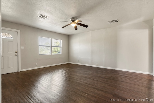 spare room featuring a textured ceiling, dark hardwood / wood-style floors, and ceiling fan