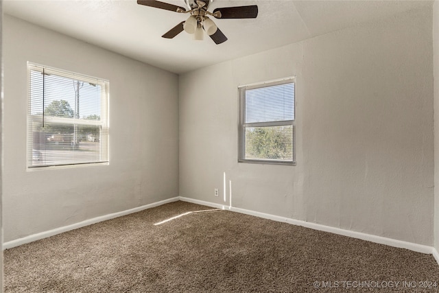 carpeted spare room with ceiling fan