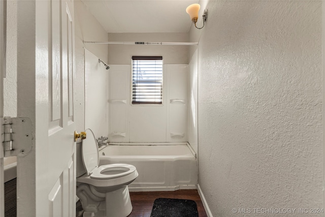 bathroom with toilet, shower / washtub combination, and wood-type flooring