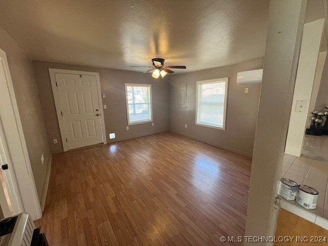 entryway with light hardwood / wood-style floors, a healthy amount of sunlight, and ceiling fan