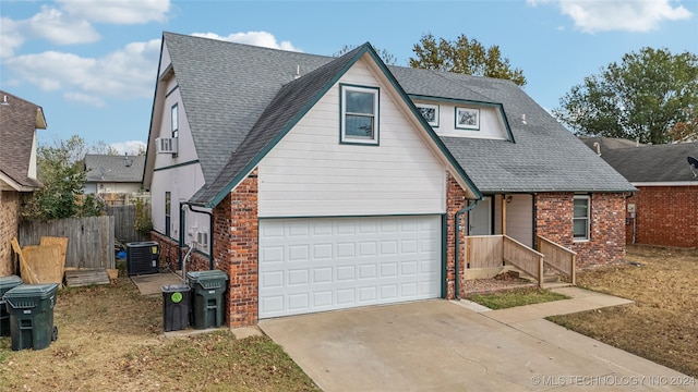 view of front of house featuring central AC and a garage