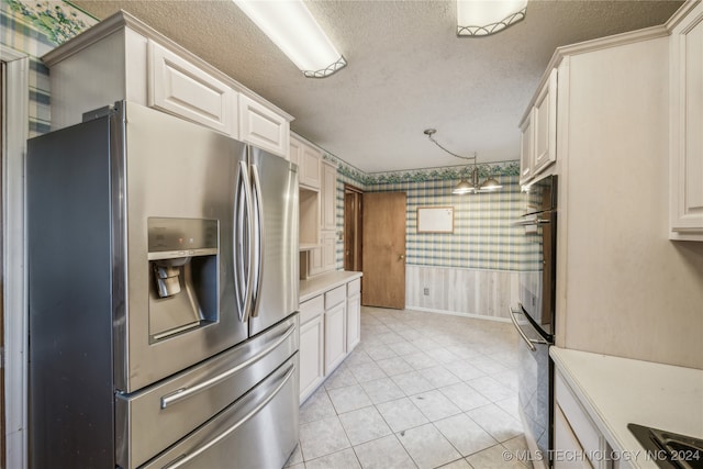 kitchen with black appliances, white cabinets, decorative light fixtures, and a textured ceiling