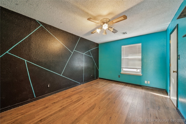 bonus room featuring hardwood / wood-style floors, a textured ceiling, and ceiling fan