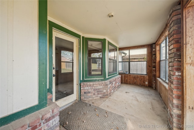 unfurnished sunroom with a wealth of natural light