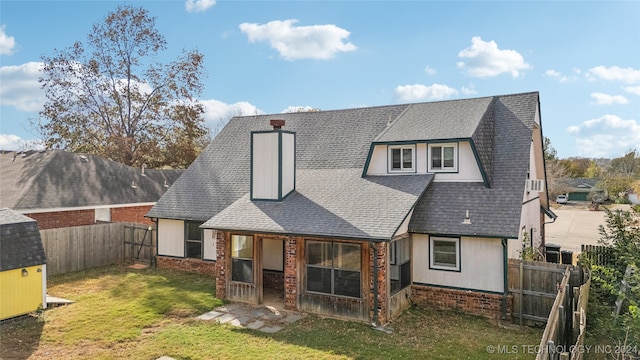 rear view of property with a yard