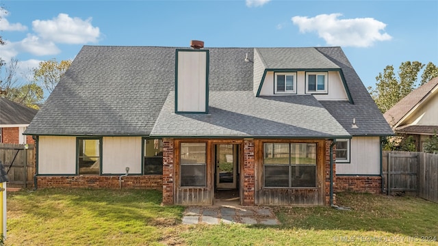 rear view of house with a yard