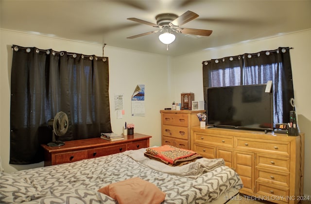 bedroom featuring ceiling fan and ornamental molding