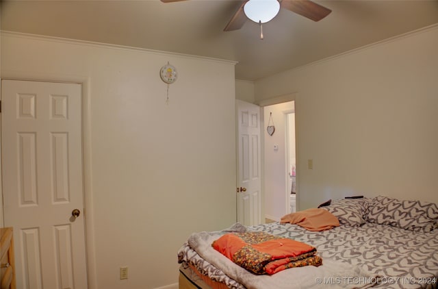 bedroom with ceiling fan and crown molding