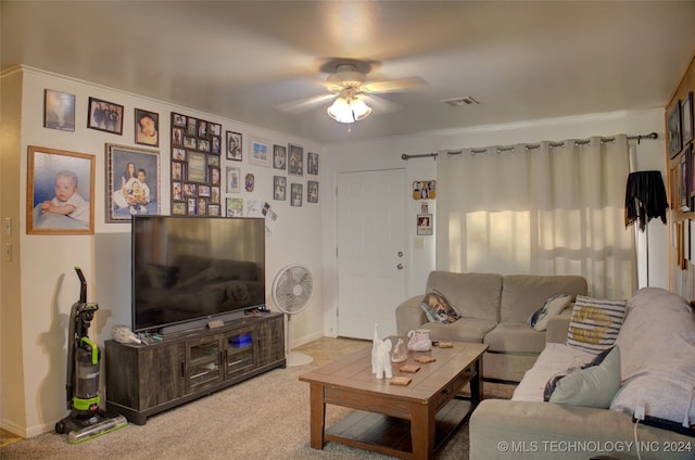 living room with carpet floors, ceiling fan, and ornamental molding