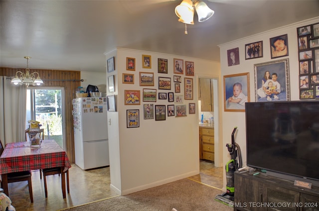 interior space featuring a notable chandelier and light carpet