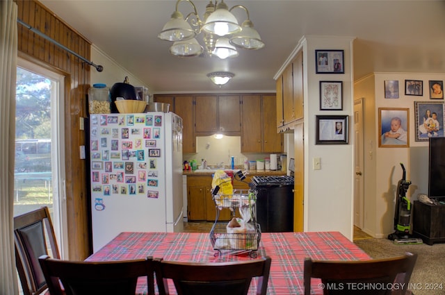 kitchen featuring sink, black stove, light colored carpet, and white refrigerator