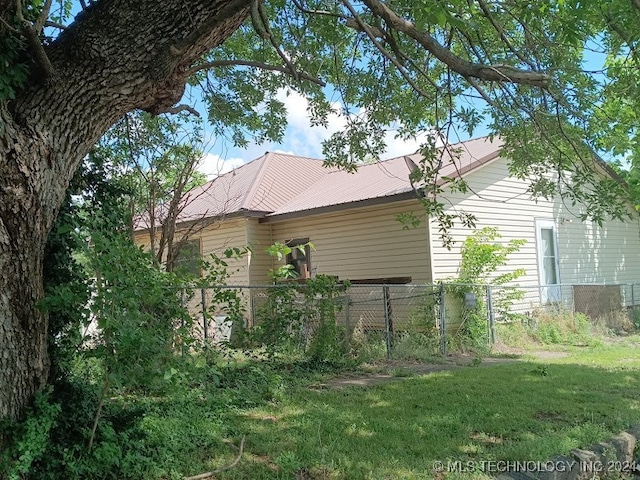 view of side of home with a lawn