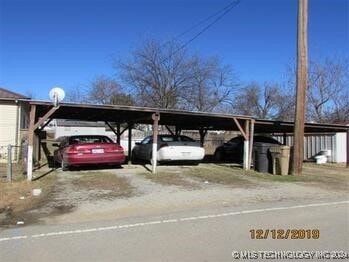 view of parking / parking lot with a carport