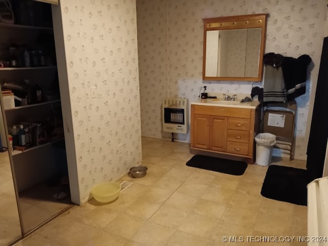 bathroom featuring vanity and heating unit