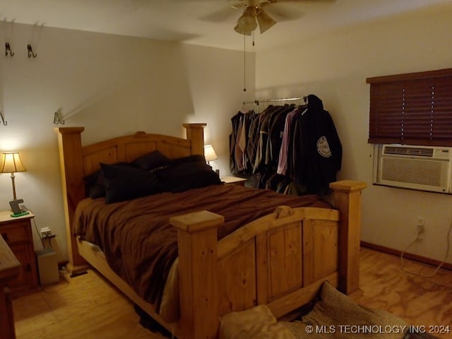 bedroom with ceiling fan and cooling unit