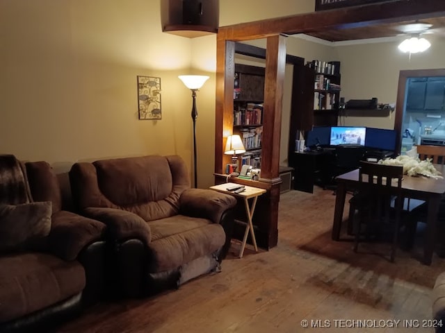 living room with beam ceiling, hardwood / wood-style flooring, and ceiling fan