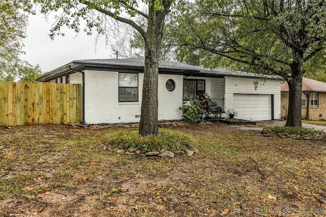 ranch-style home featuring a garage