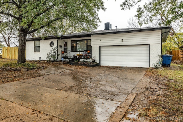 single story home with a garage and covered porch