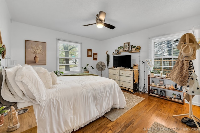 bedroom with hardwood / wood-style floors and ceiling fan