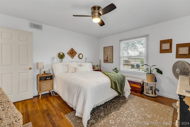 bedroom with ceiling fan and dark hardwood / wood-style flooring