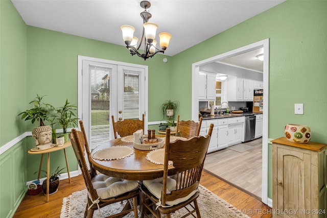 dining room featuring light hardwood / wood-style floors and an inviting chandelier