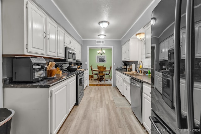 kitchen with stainless steel appliances, light hardwood / wood-style floors, sink, crown molding, and white cabinetry