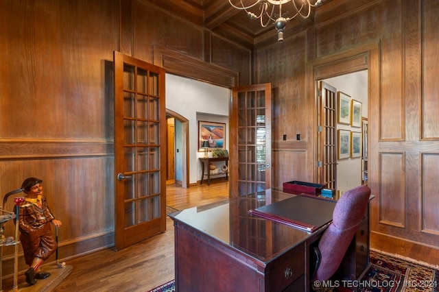 home office featuring coffered ceiling, beamed ceiling, hardwood / wood-style flooring, and french doors