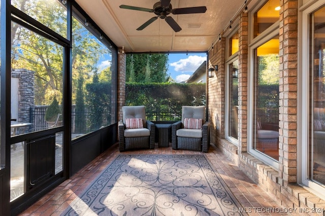 unfurnished sunroom featuring plenty of natural light and ceiling fan