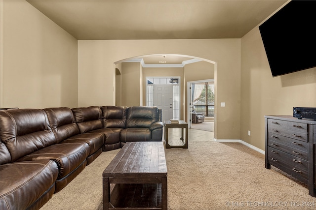 carpeted living room with ornamental molding