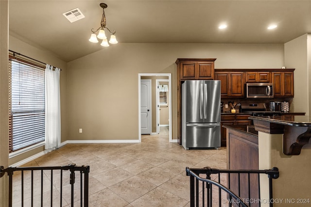 kitchen with lofted ceiling, light tile patterned floors, pendant lighting, a notable chandelier, and stainless steel appliances